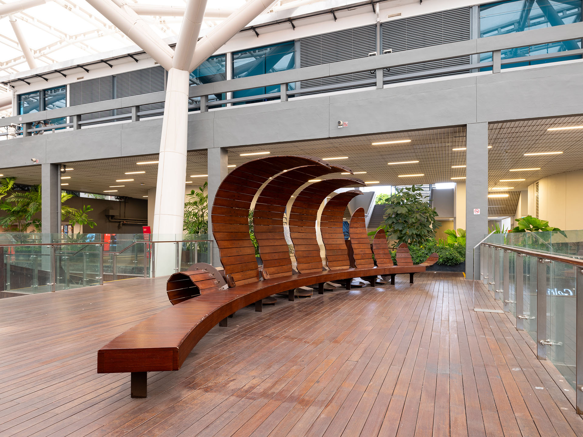 artwork-fern-front Wooden bench with curved panels shaped like a fern