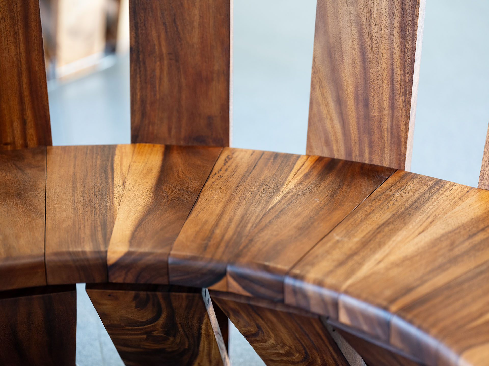 artwork-tete-a-tete-bench Closeup of wooden bench seat
