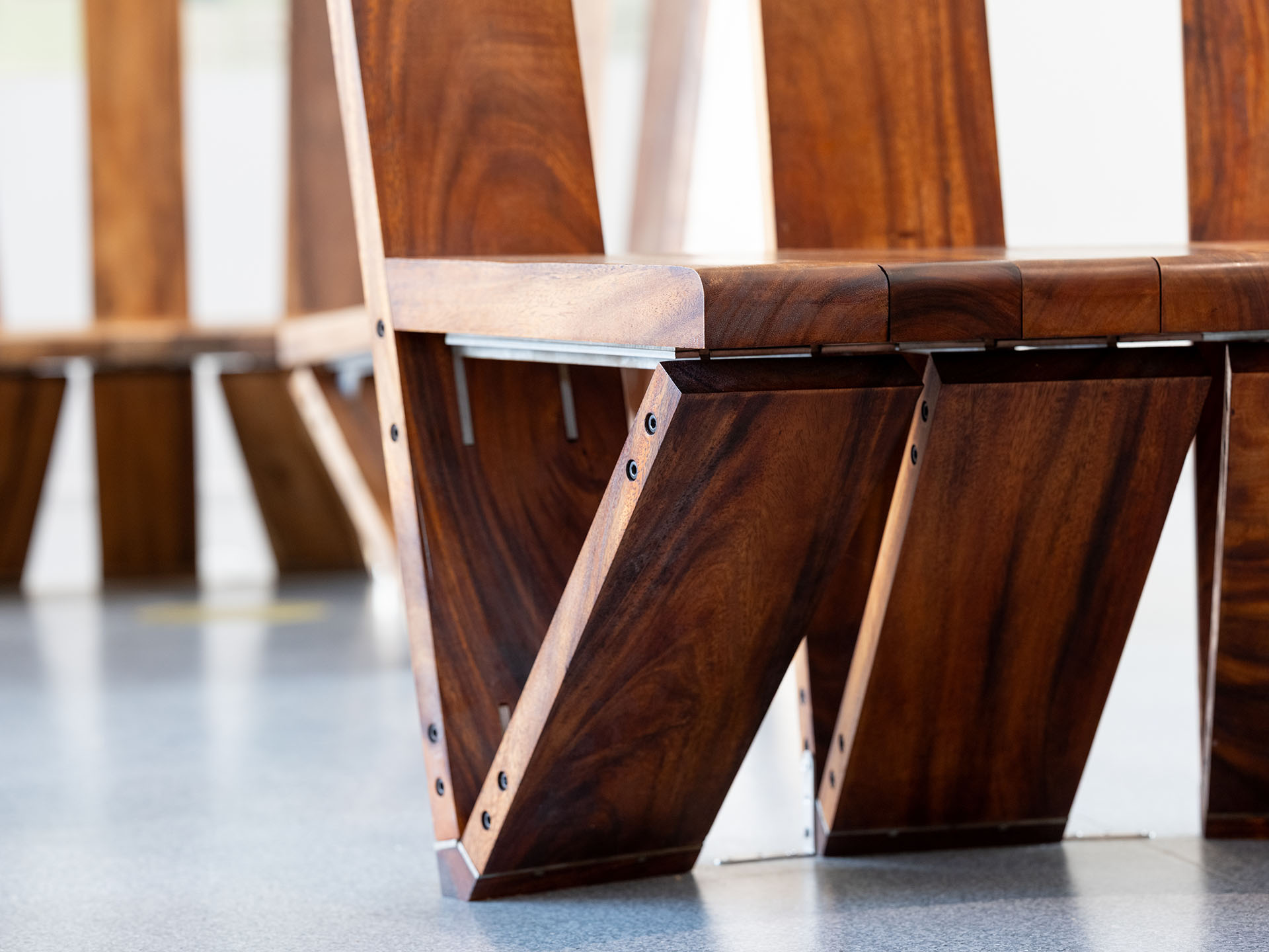 artwork-tete-a-tete-leg Closeup of wooden bench leg