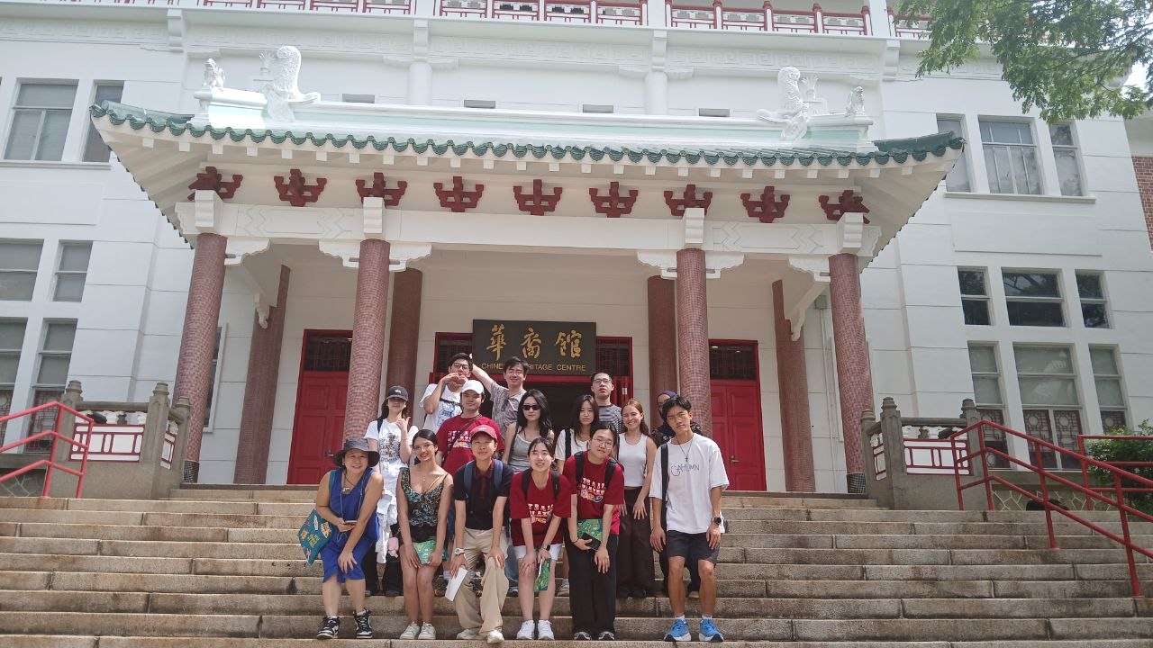 cat-walk-gem-summer-2025-group-chc Group photo of people standing on the steps in front of a white and red Chinese-style building