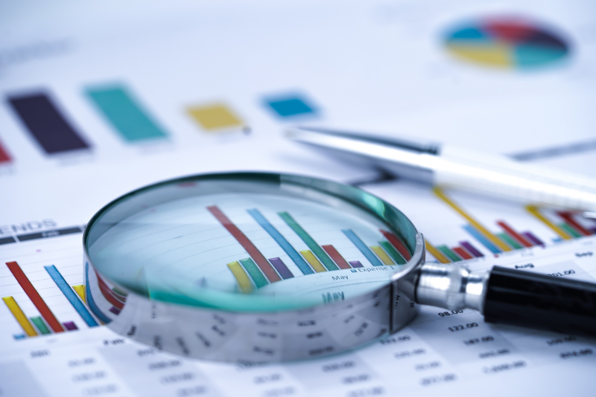 Magnifying glass on charts graphs spreadsheet paper. Financial development, Banking Account, Statistics, Investment Analytic research data economy, Stock exchange trading
