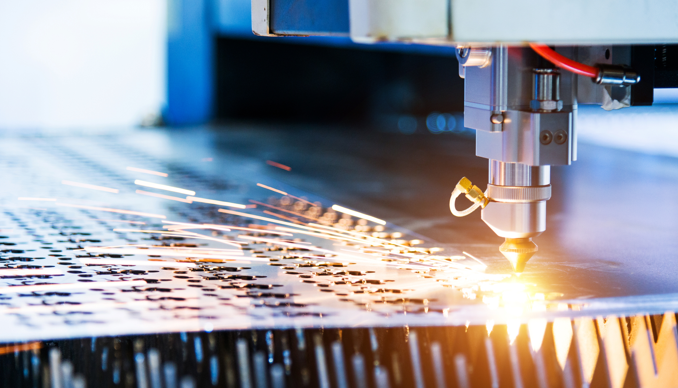 Laser cutting metal sheet with sparks flying stock photo
