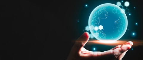 Hand holding an illustration of a modern globe
