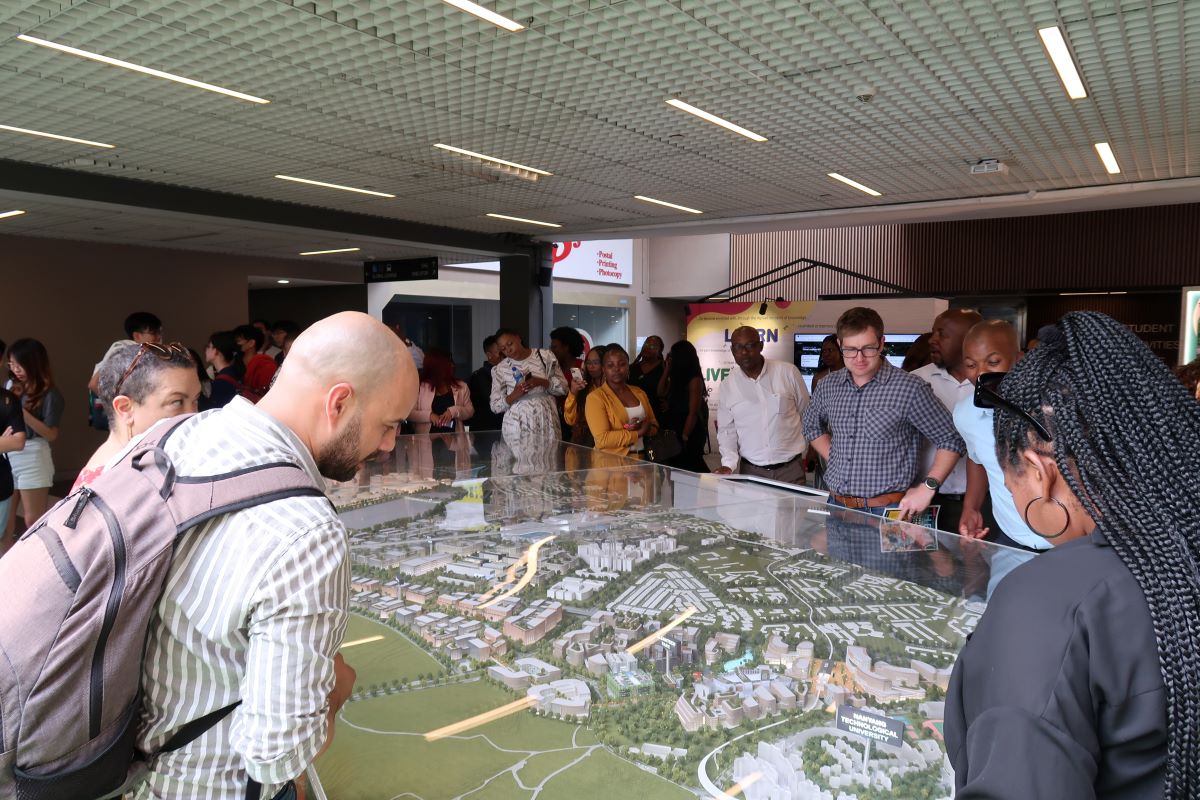GIBS MBA students looking at model of NTU