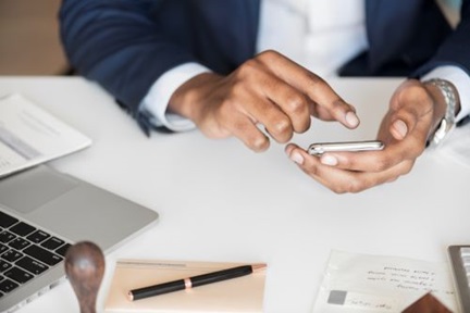 Closeup of businessman using phone.