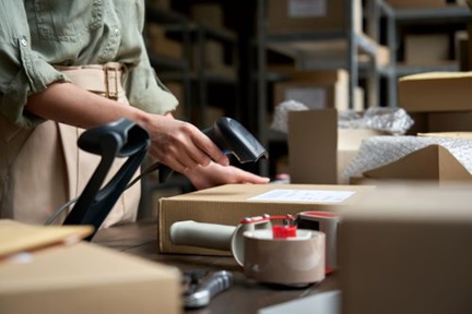 Online seller preparing parcel for shipping.