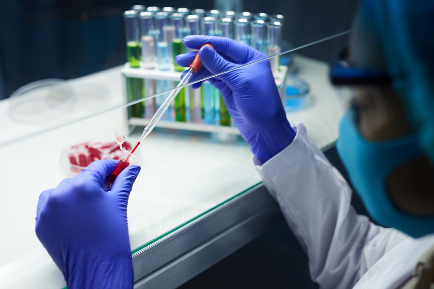 scientist sampling blood in test tubes while working on research in laboratory