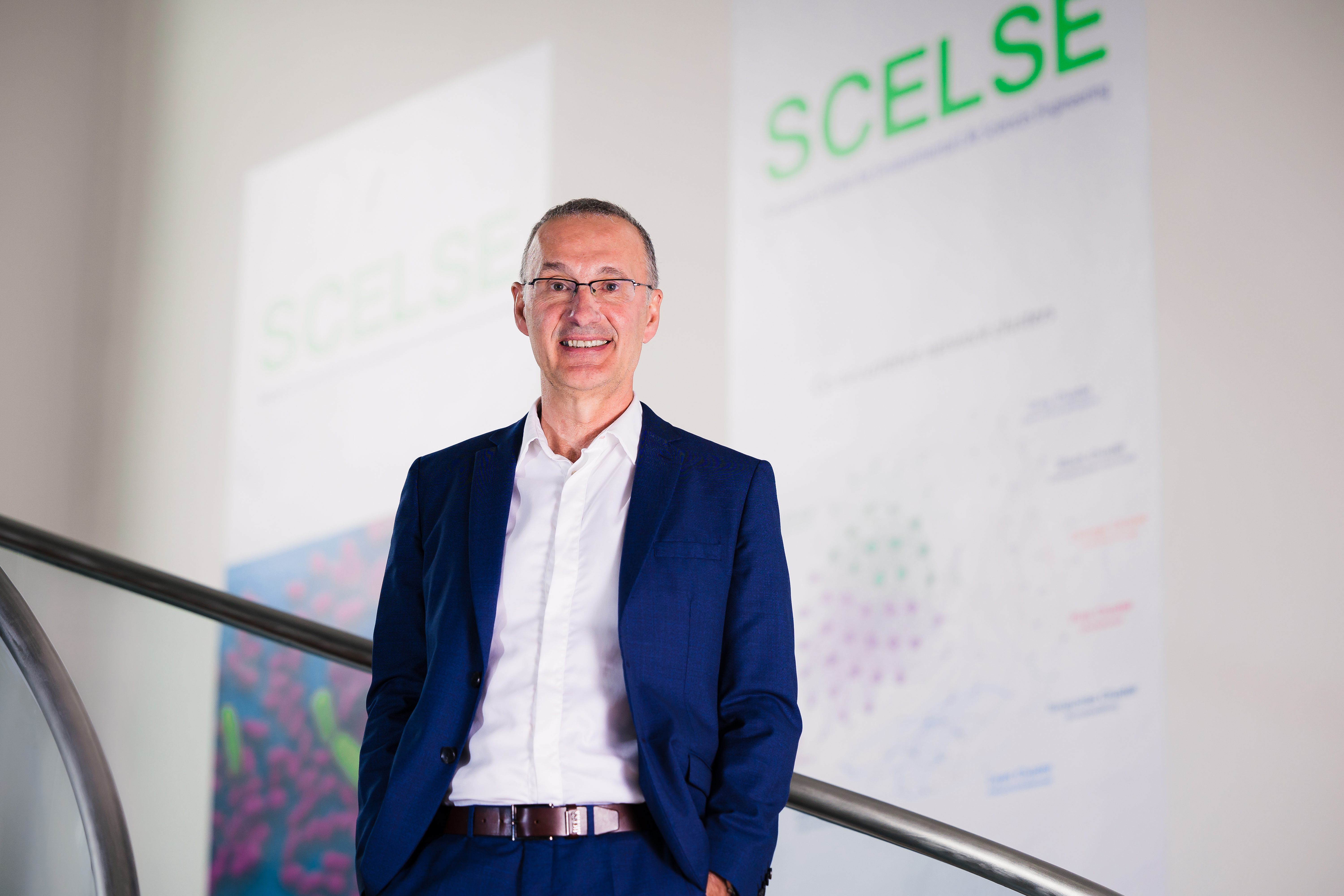 Photo of Prof Alain Filloux standing on the stairs