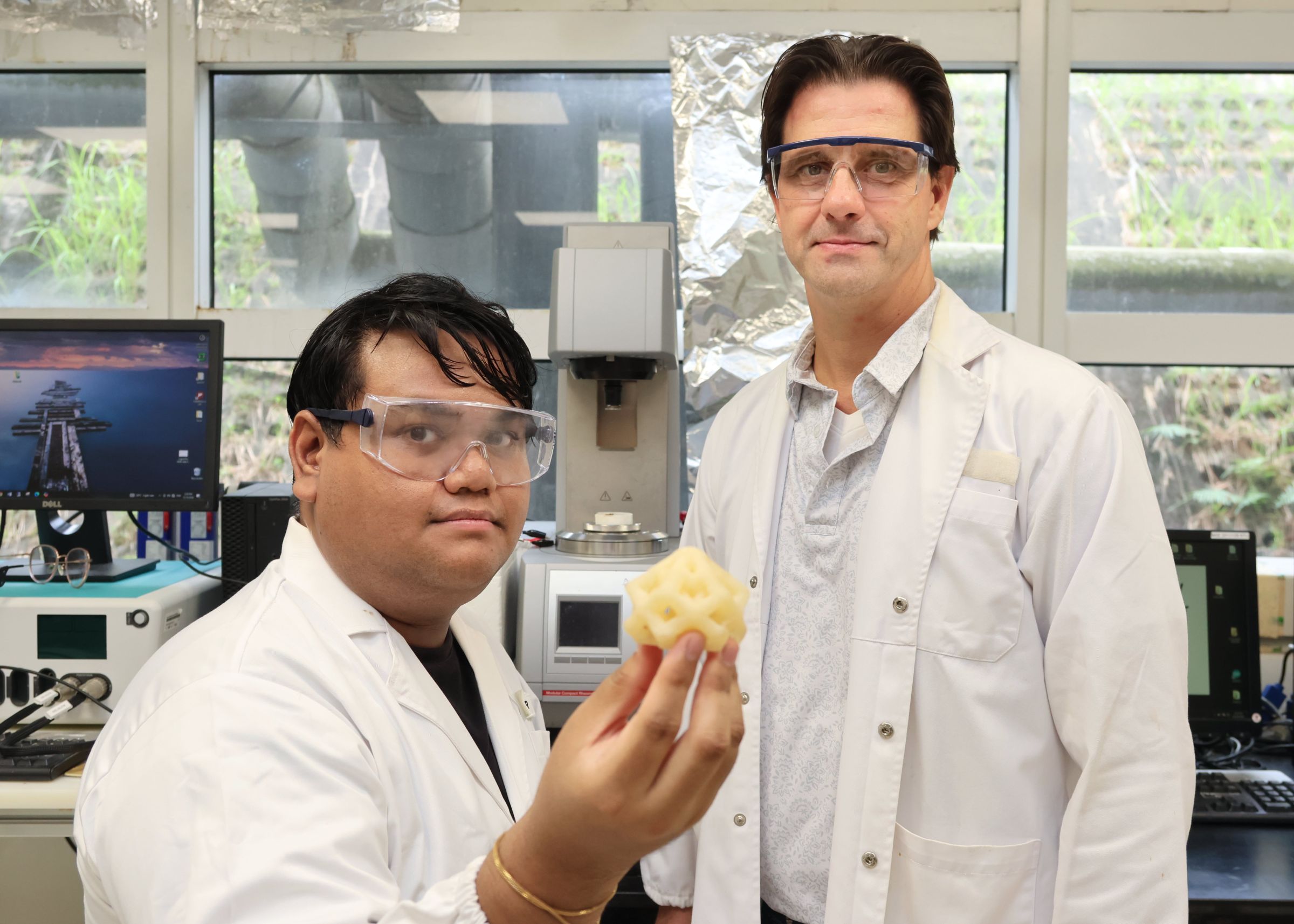 PhD student Naziruddin Ali (L) and Prof Terry Steele posing with a 3D printed model made using the aryl diazirine photoinitiators they developed. Credit: NTU Singapore