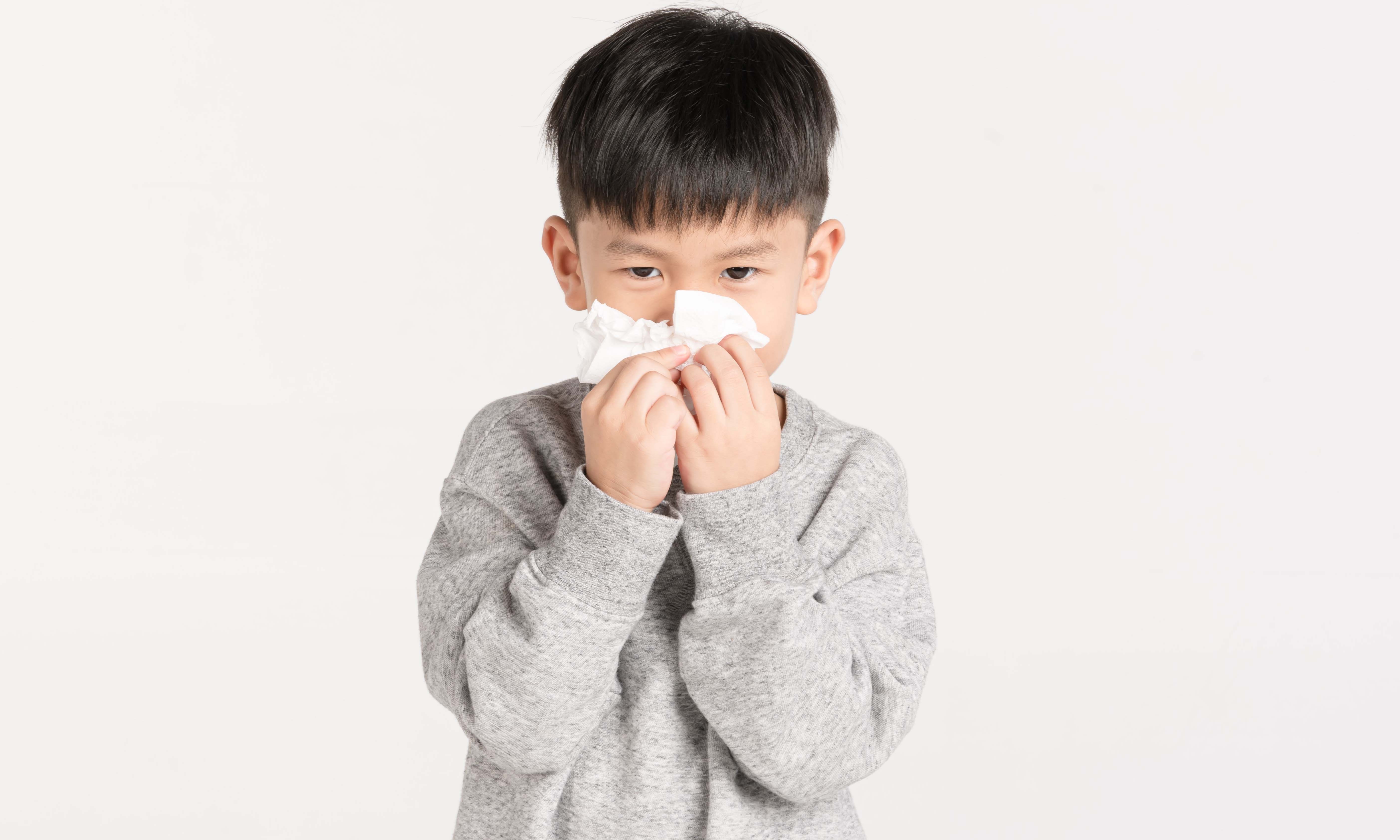 A boy sneezing 