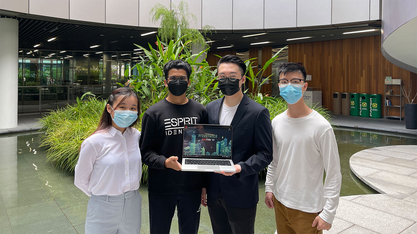 Group of 4, one female and 3 male students, 2 male students are holding a laptop.