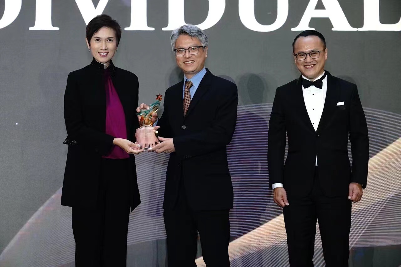 Awardee receiving the award on stage.