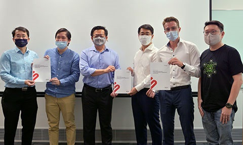 A group of men wearing mask are holding certificates.