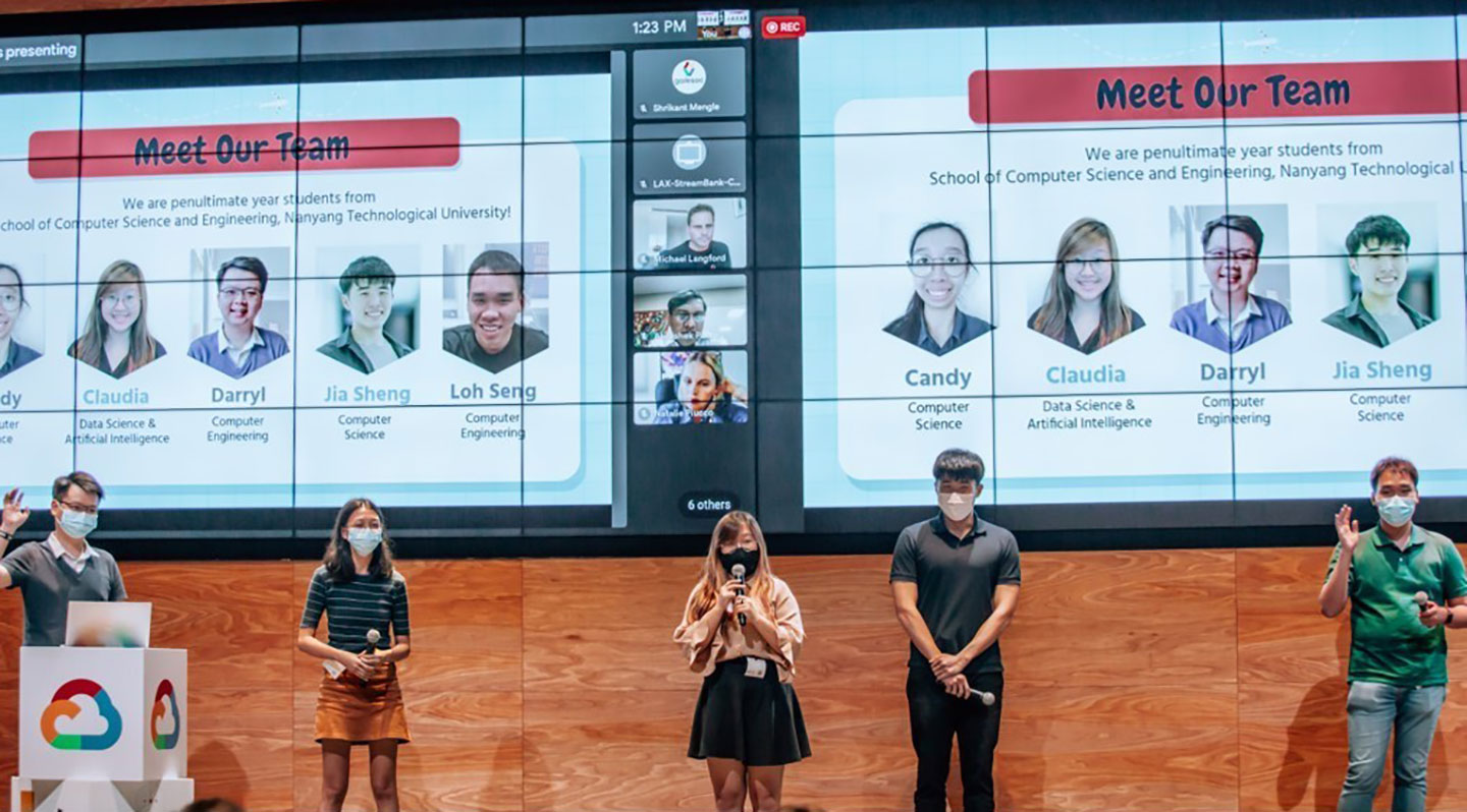 Photo of undergraduate student team on stage presenting.