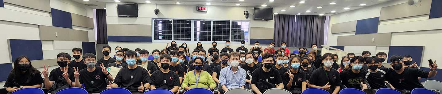 A panorama photo of a group of students in a small Lecture Theatre.