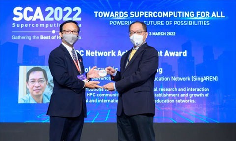 Photo of awardee receiving the award on stage.