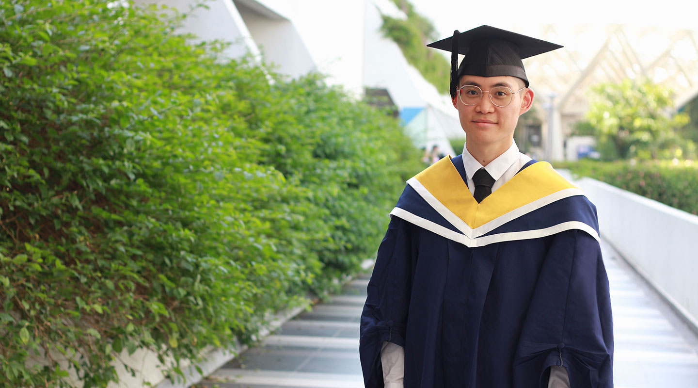 Photo of an undergraduate in convocation gown and cap.
