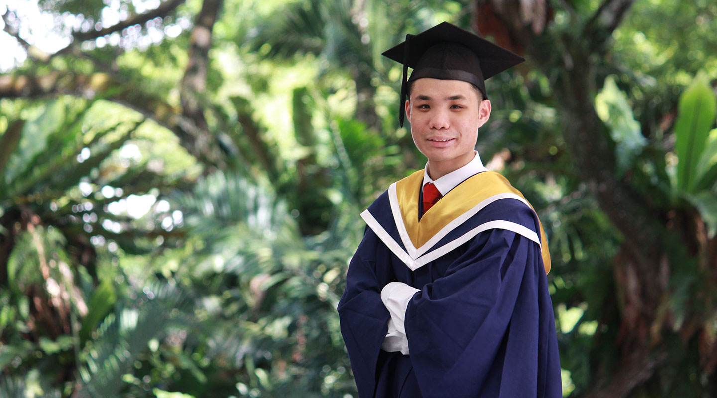 Photo of an undergraduate in convocation gown and cap.