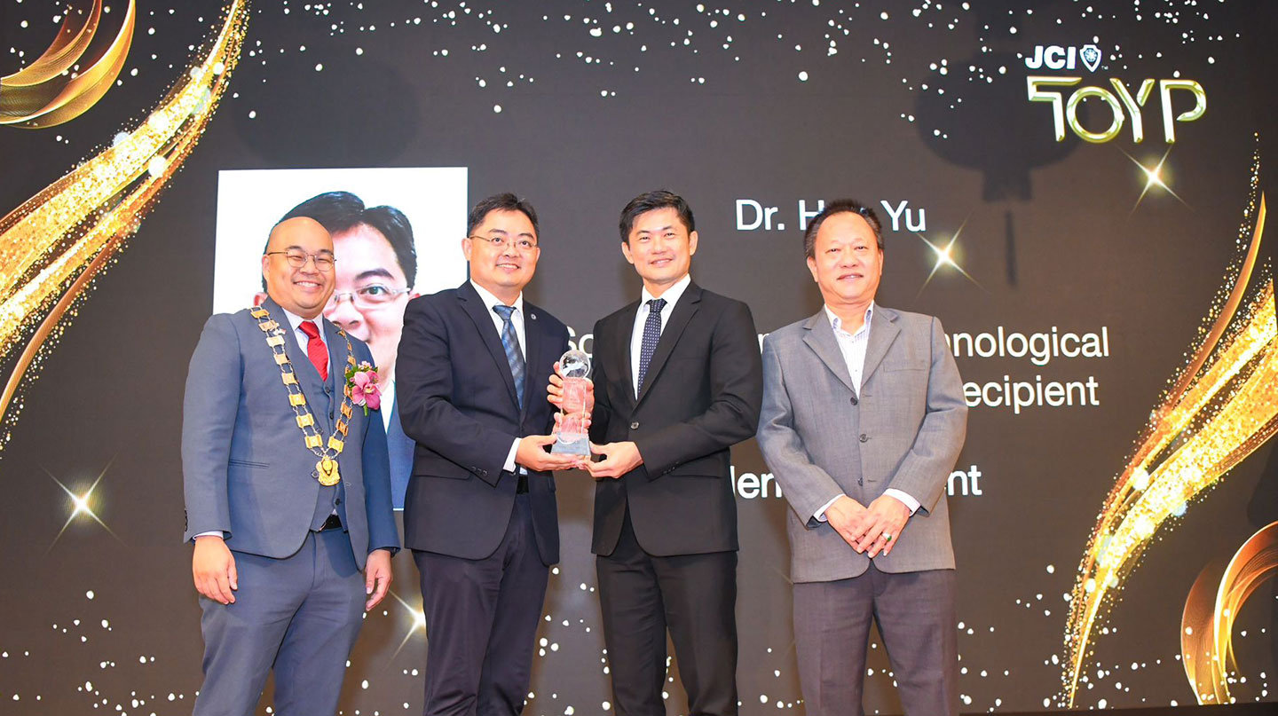 Photo of awardee receiving award on stage.