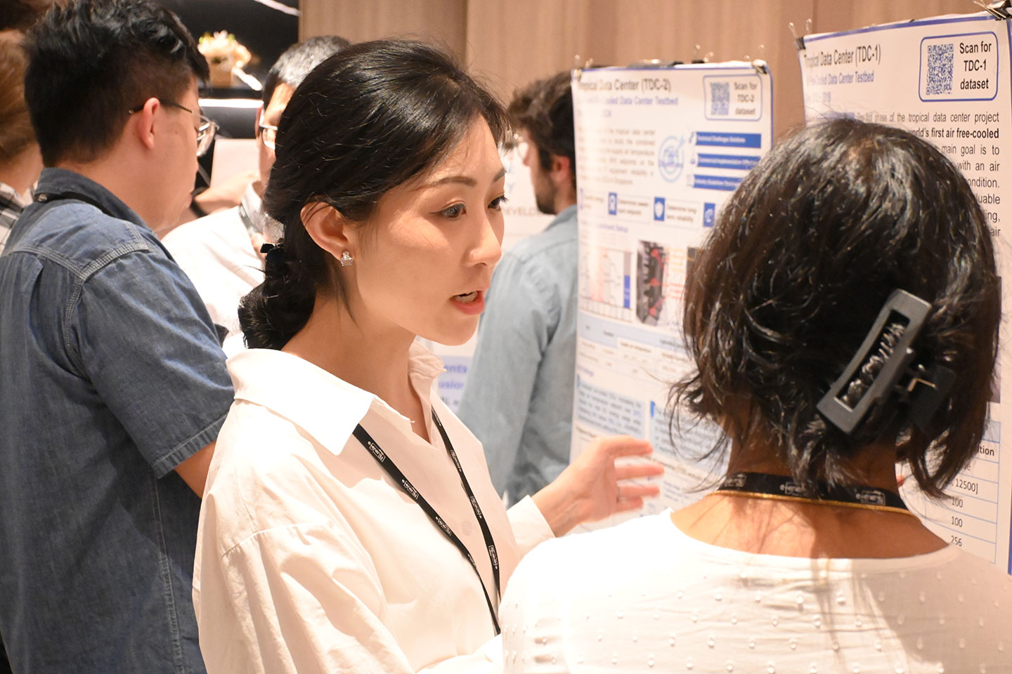CCDS researcher presenting tropical data centre projects during poster session.