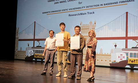 Thumbnail photo of ACM SIGSOFT Distinguished Paper Award presentation on stage.