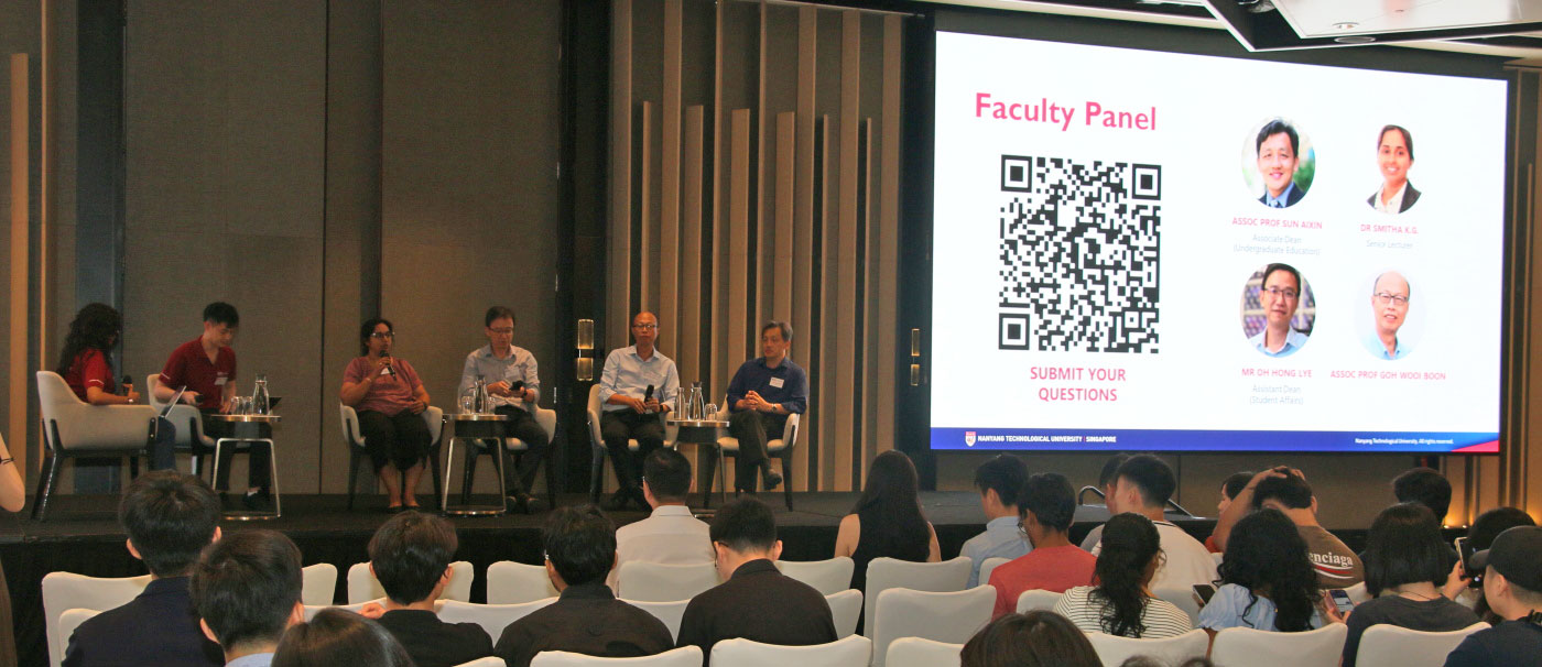 Photo of Faculty Panel with two moderators on stage.