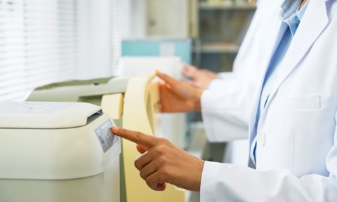Group of researchers using scientific equipment