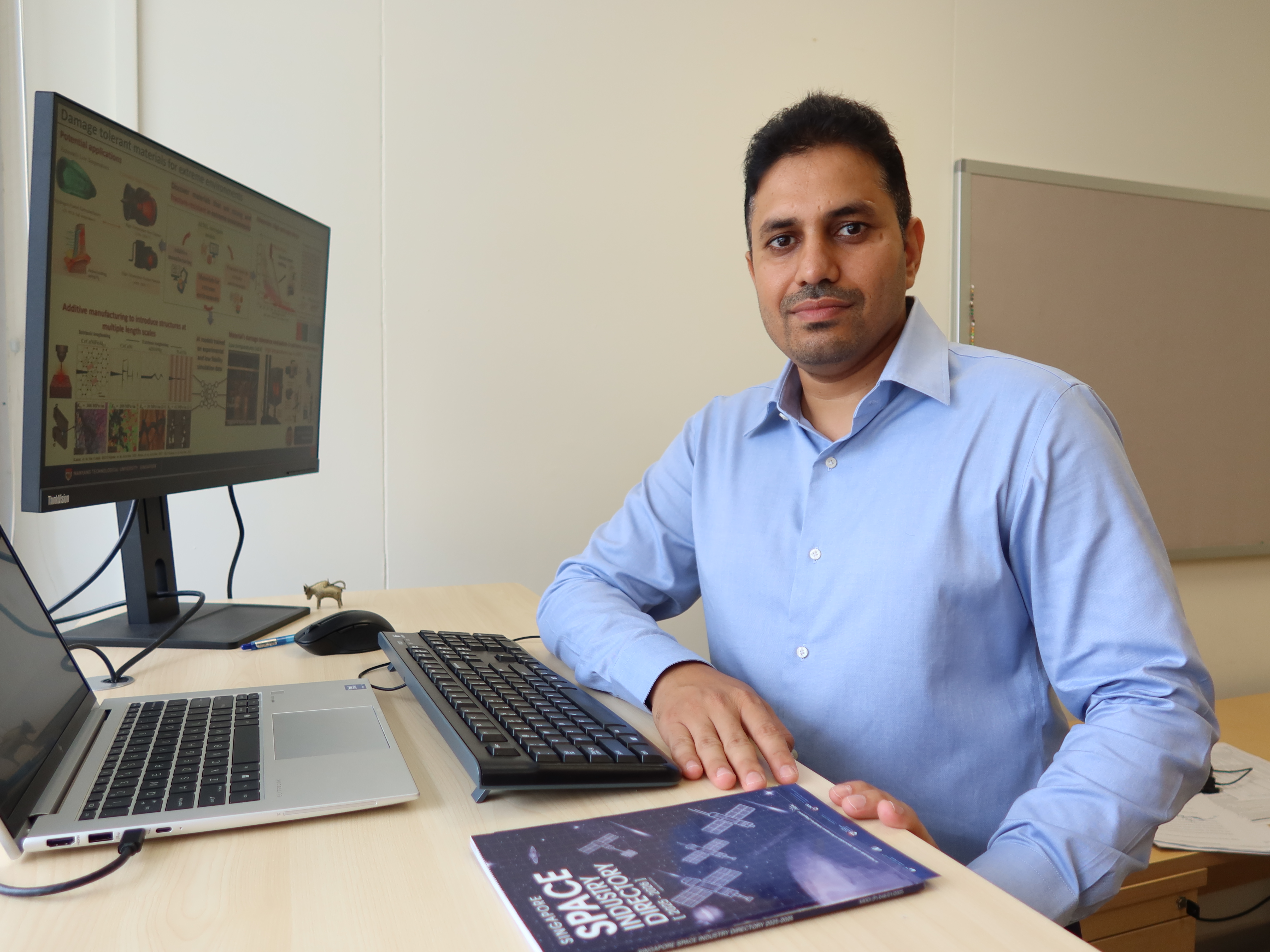 Asst Prof Punit Kumar seated at his desk in his office at NTU