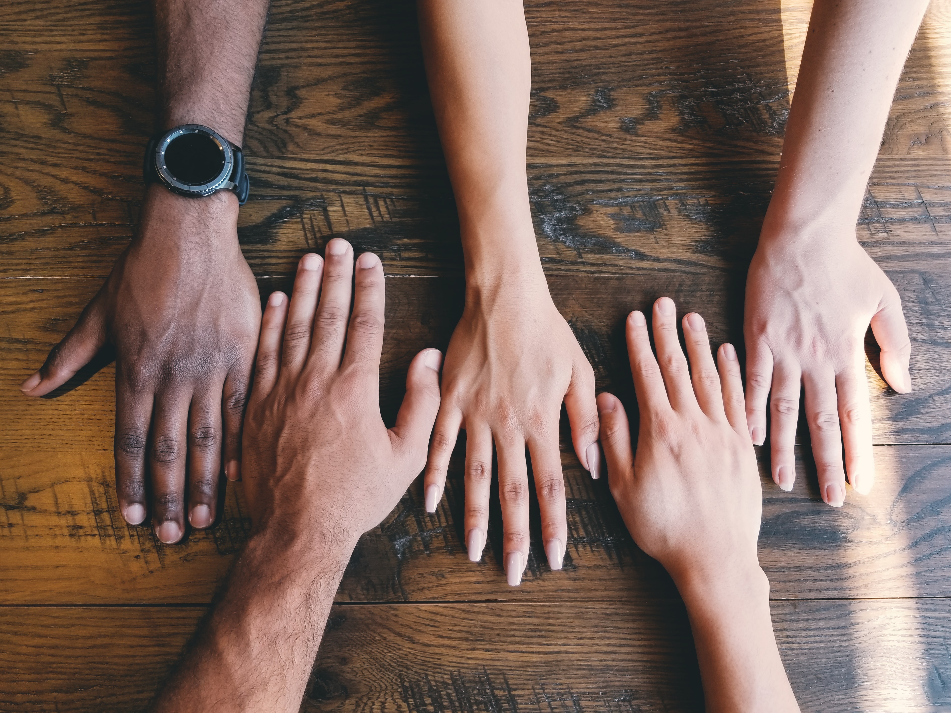 hands of different skin colours