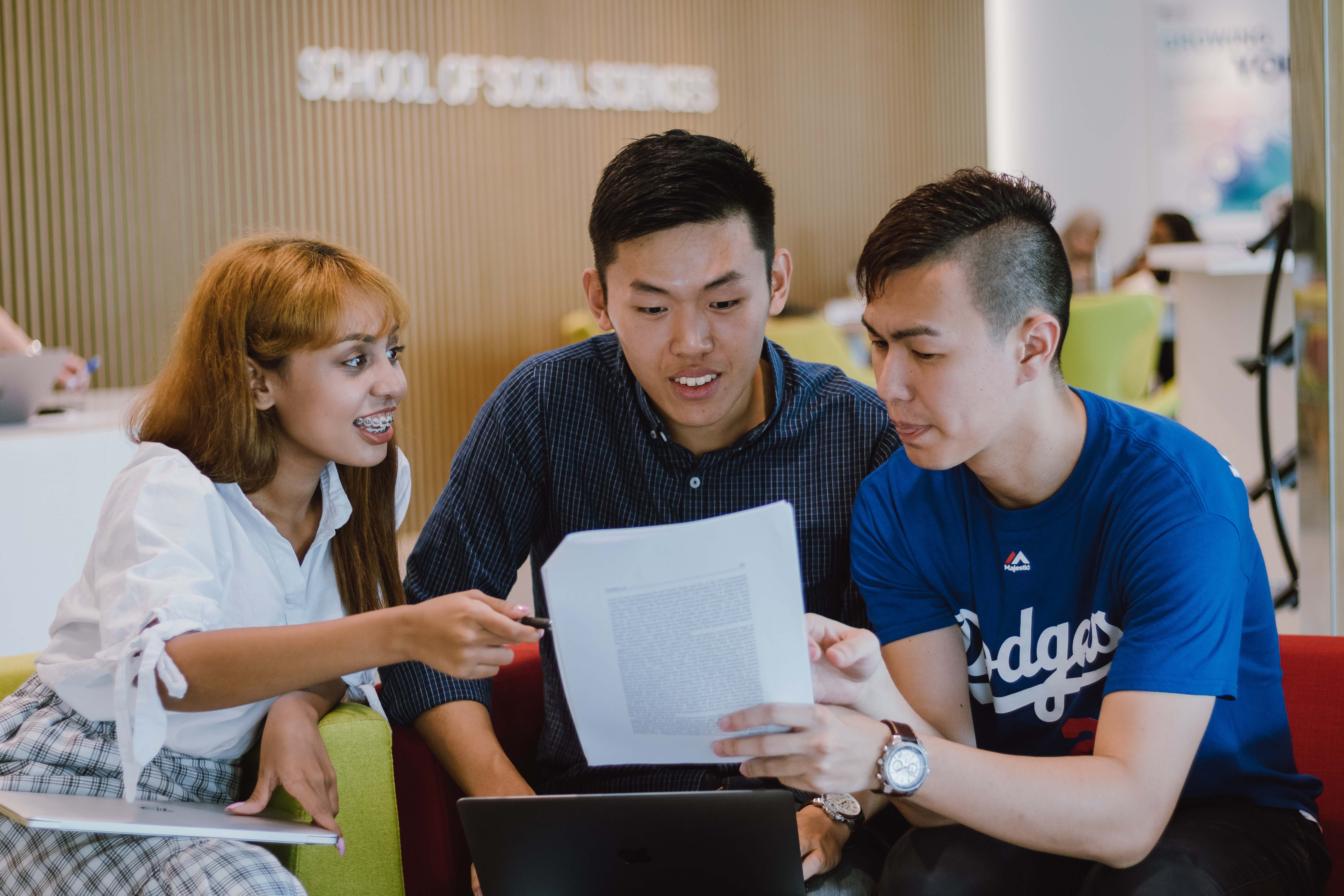 three students in discussion