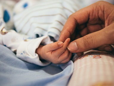 Mother touches baby's fingers