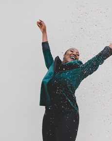 woman covered in confetti being happy