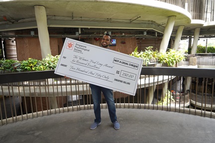 Paul Patinadan holds his prize