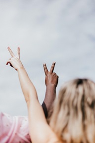interracial friends showing peace signs