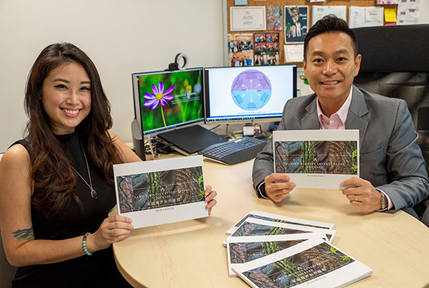 Researchers holding up their new book