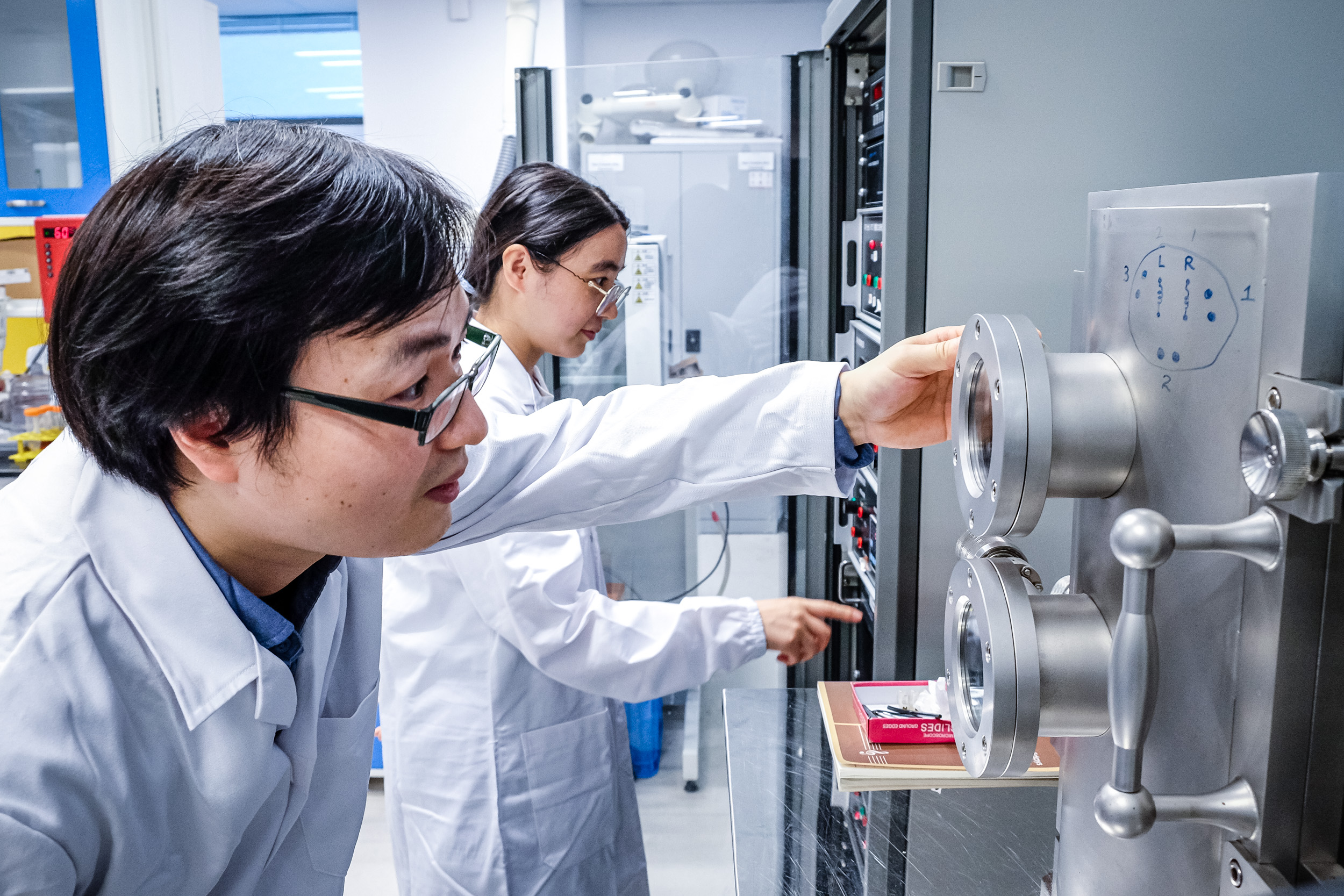 Professor examining machinary