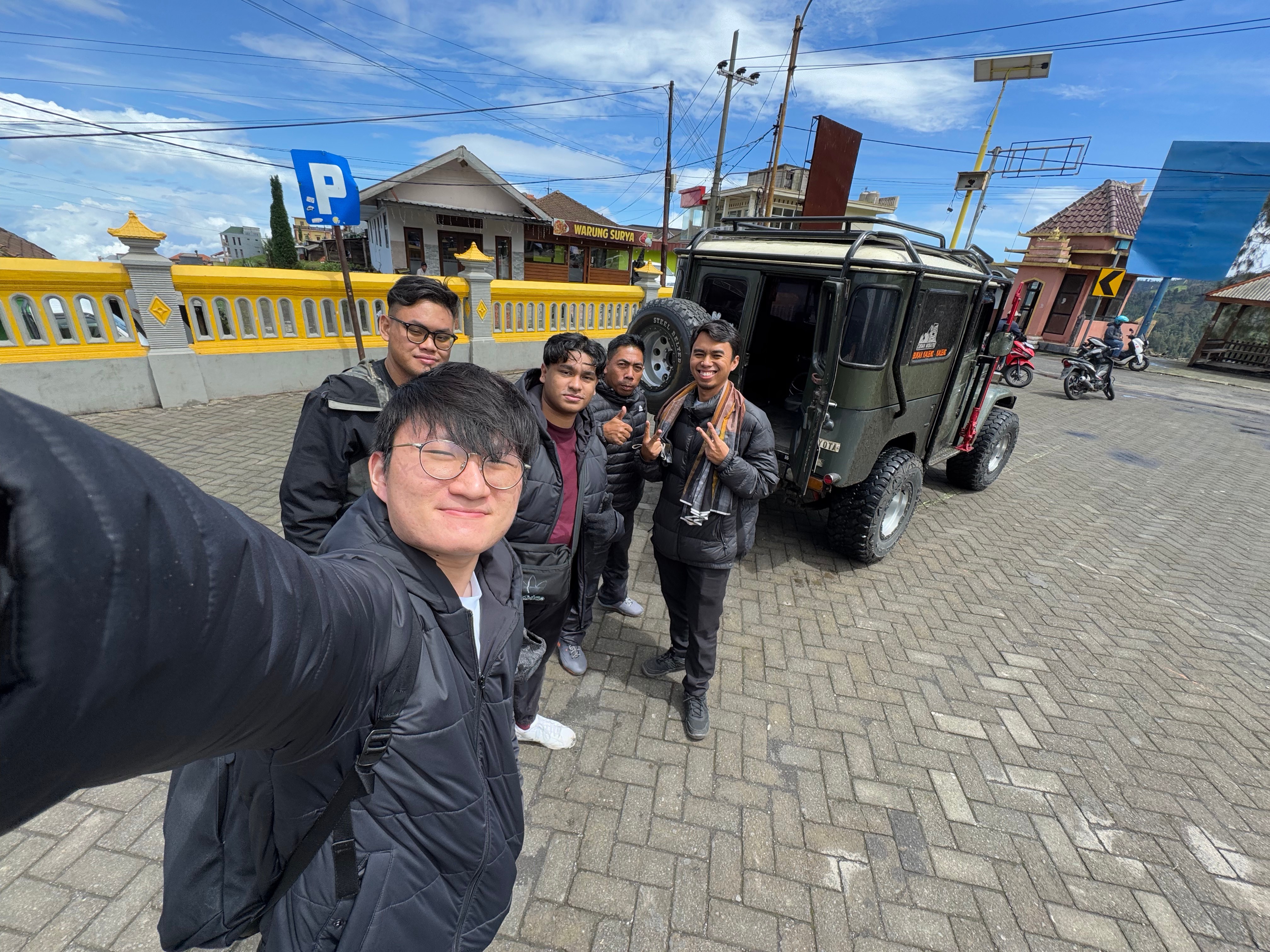 Student on overseas trip with a jeep