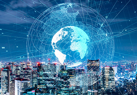 A globe graphic icon against a range of city skyscrapers at night