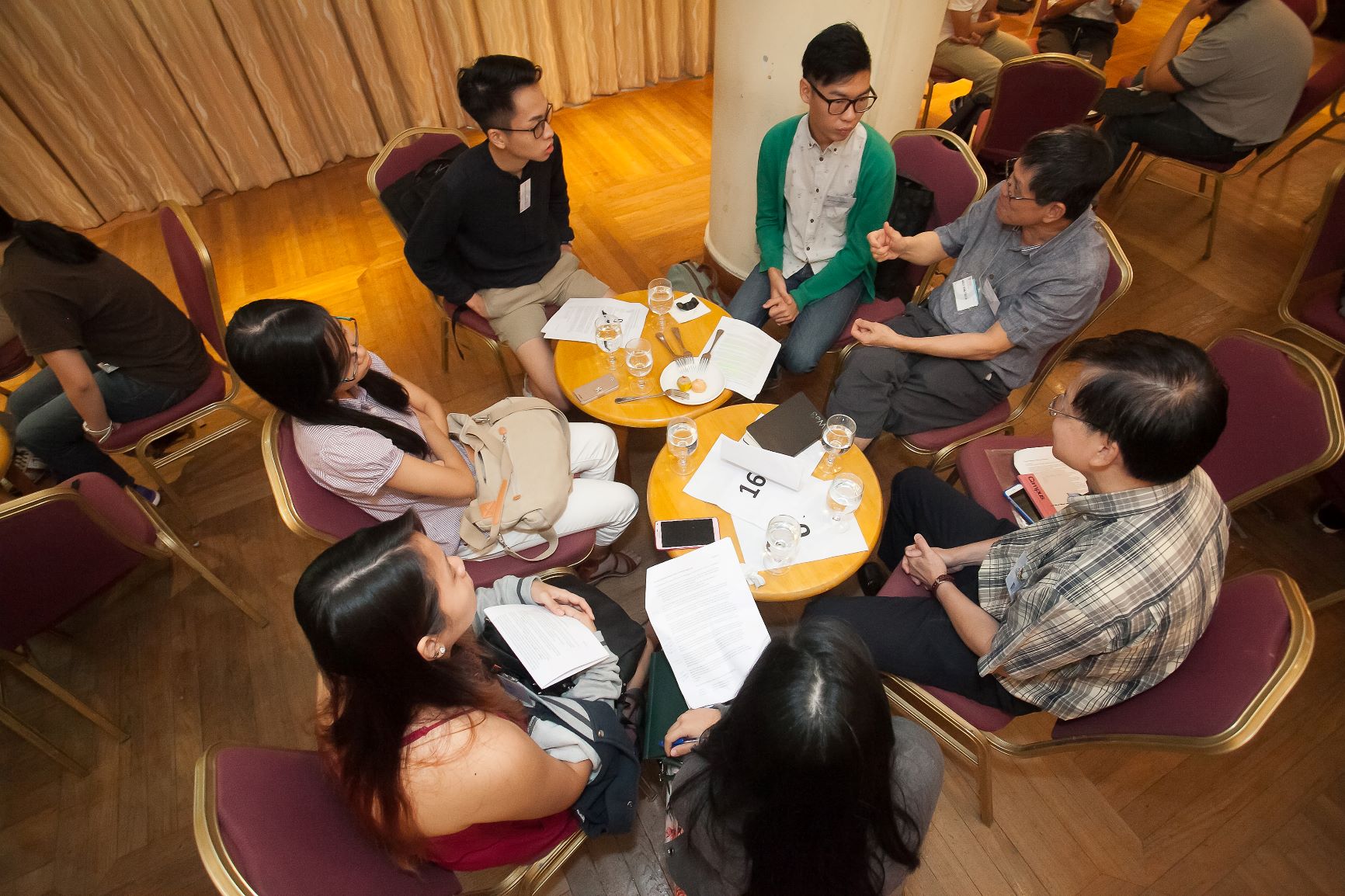 Students and mentors sitting in a circle having a discussion.