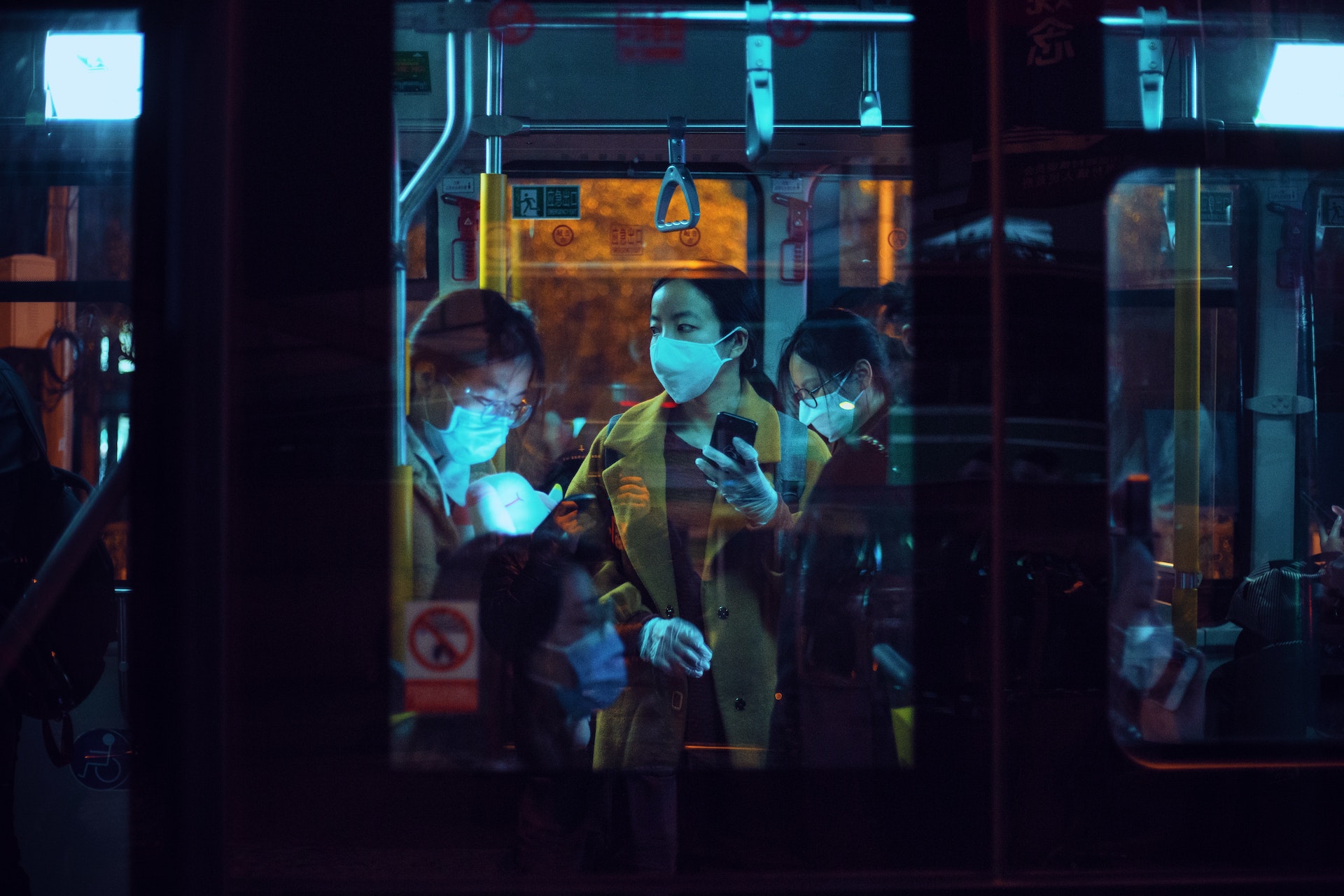 Individuals wearing face masks in a public transport