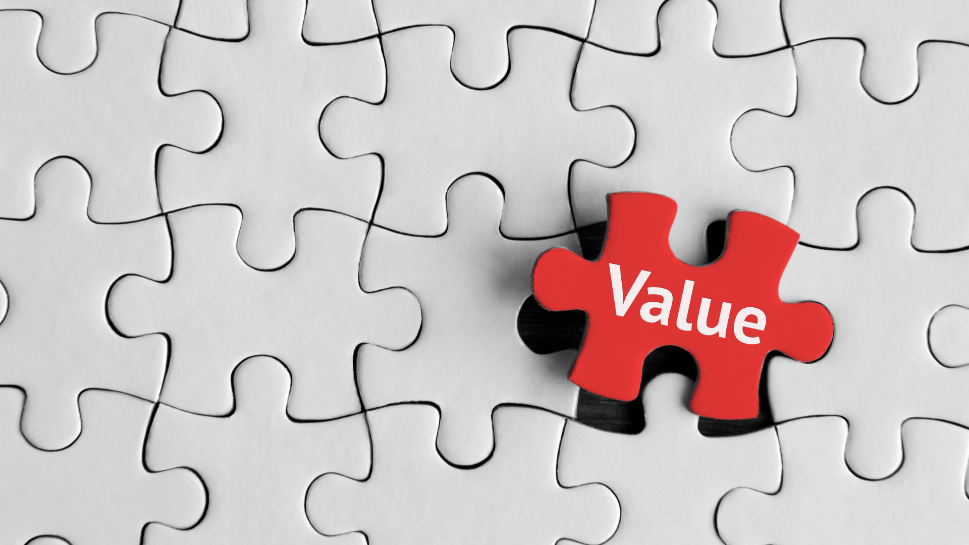 Puzzle pieces with one red puzzle piece having the word Value on it