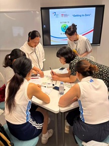 Interns at work: explaining the Getting-to-Zero (GTZ) game to workshop participants