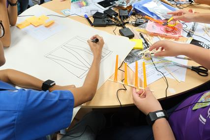 Students working on designing a prototype based on the problem posed