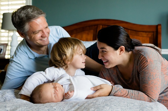 family bonding, newborn baby, young child, parents, couple, home, comfortable, cozy, older sibling